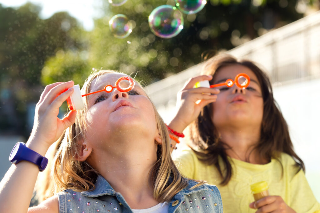 children blowing bubbles