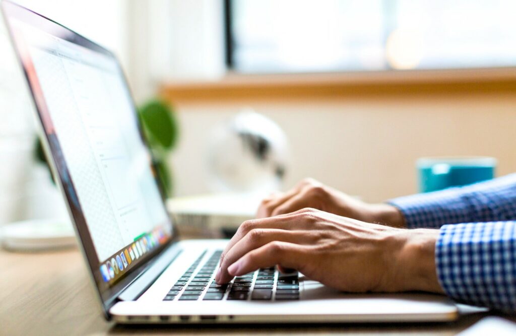 Person typing on laptop