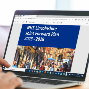 Image of a laptop open with the NHS Lincolnshire Join Forward Plan 2023 - 2028 on the screen.
