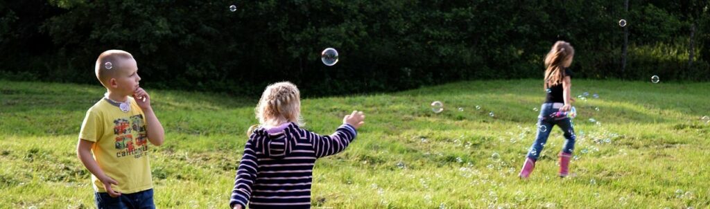 children outside playing with bubbles