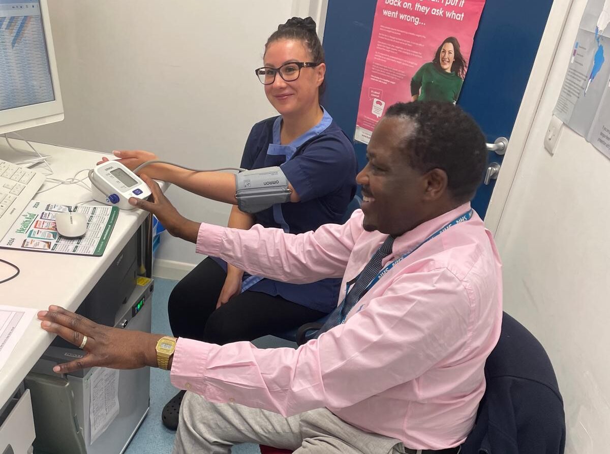 Chris, Pharmacist at Riverside Pharmacy in Sleaford carrying out a Blood Pressure check on a colleague