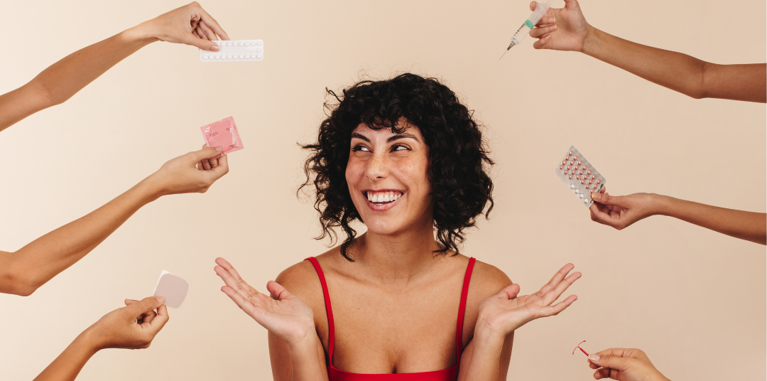 Woman with different types of contraception being held around her