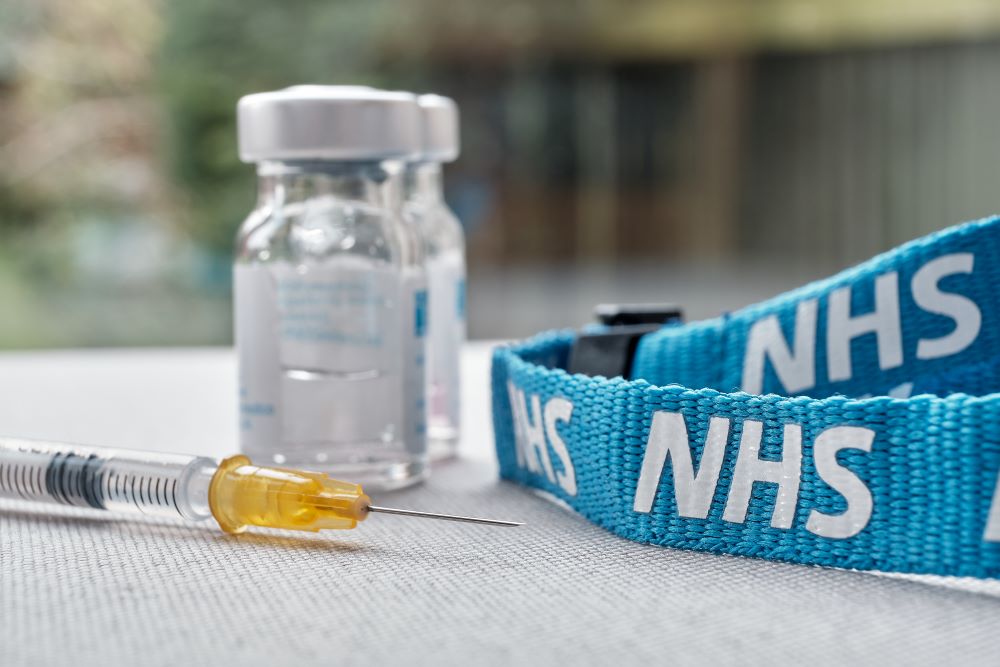 A vaccine bottle and a vaccine bottle on a table