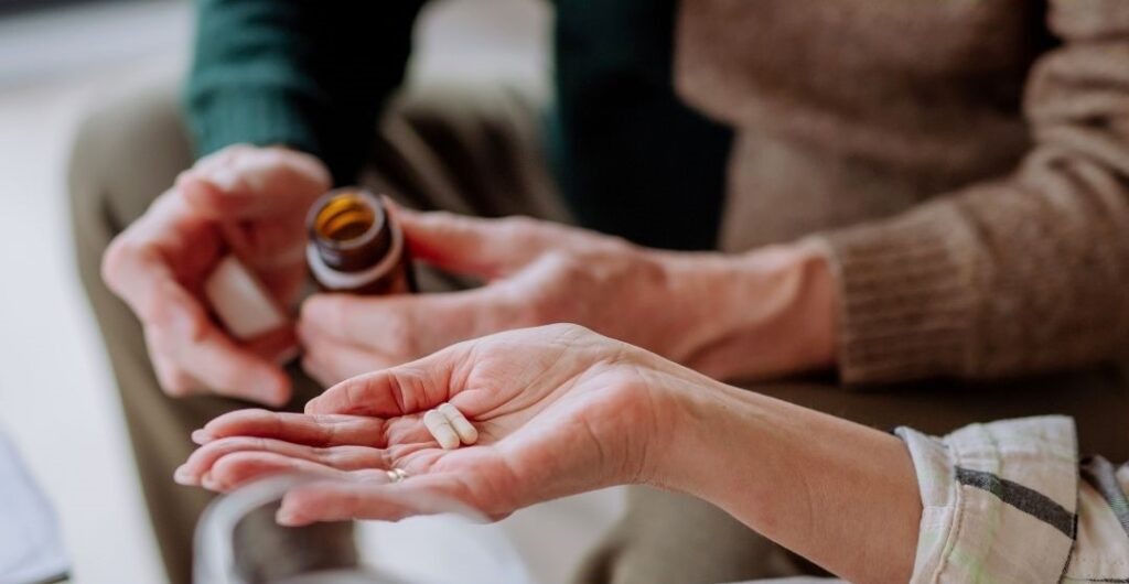 Person holding medicine pills in their hand