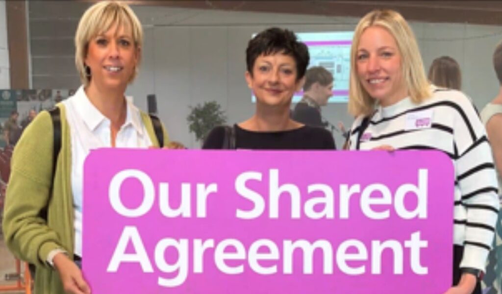 Photo of 3 members of the Washingborough Family Practice team at the at the ‘It’s All About People’ conference 2024 holding a sign saying "Our Shared Agreement"