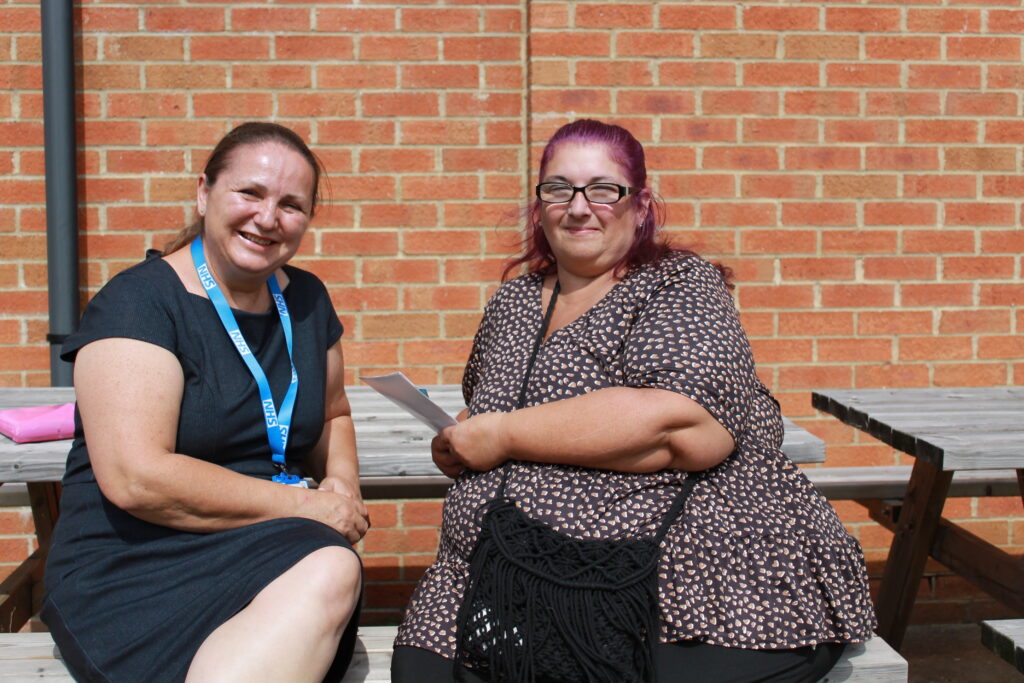 A photo of two women speaking. Elena, a social prescriber -left and Amanda, a patient - right