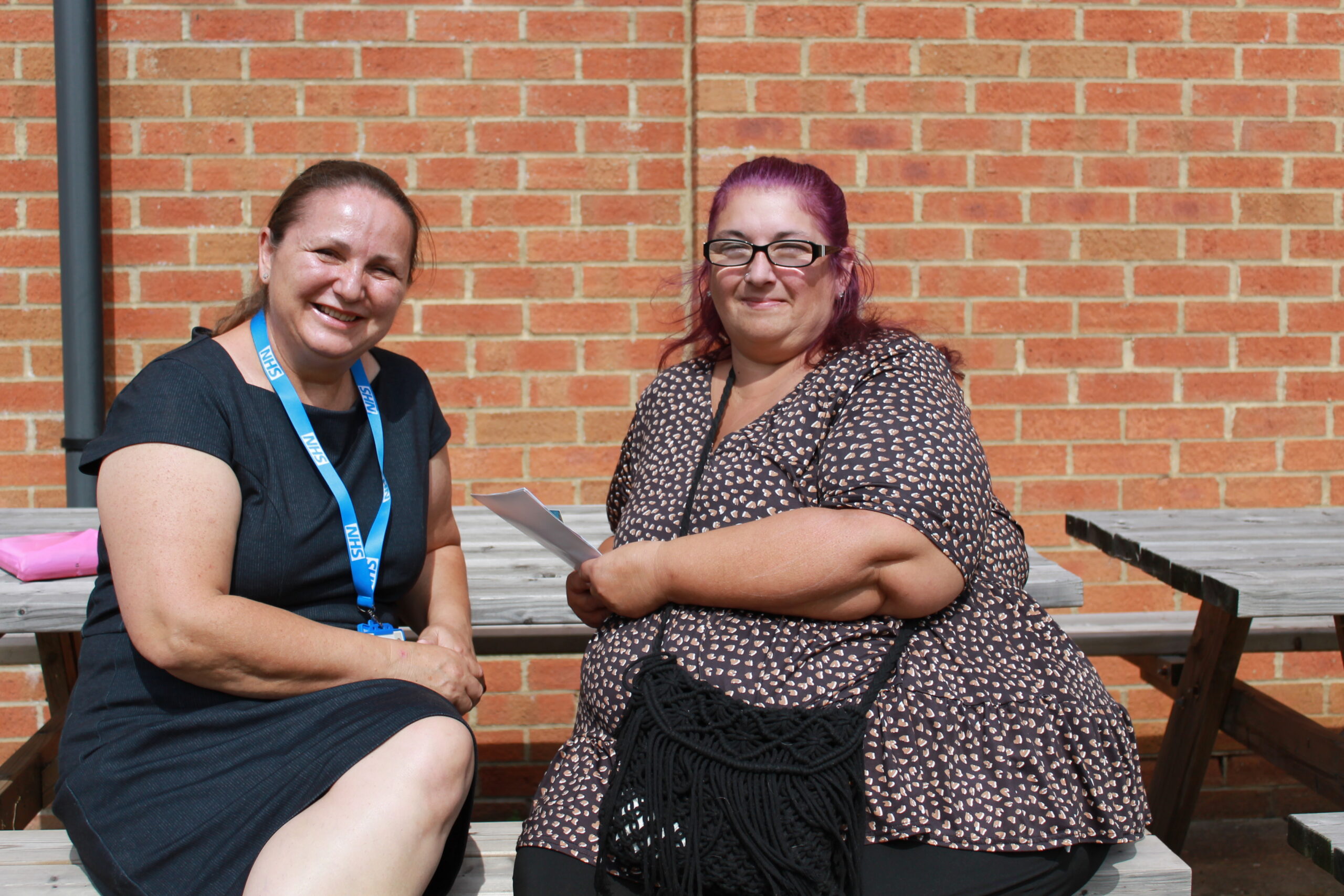 A photo of two women speaking. Elena, a social prescriber -left and Amanda, a patient - right