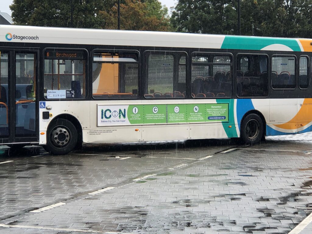 Photograph of a bus featuring an ICON advertisement 