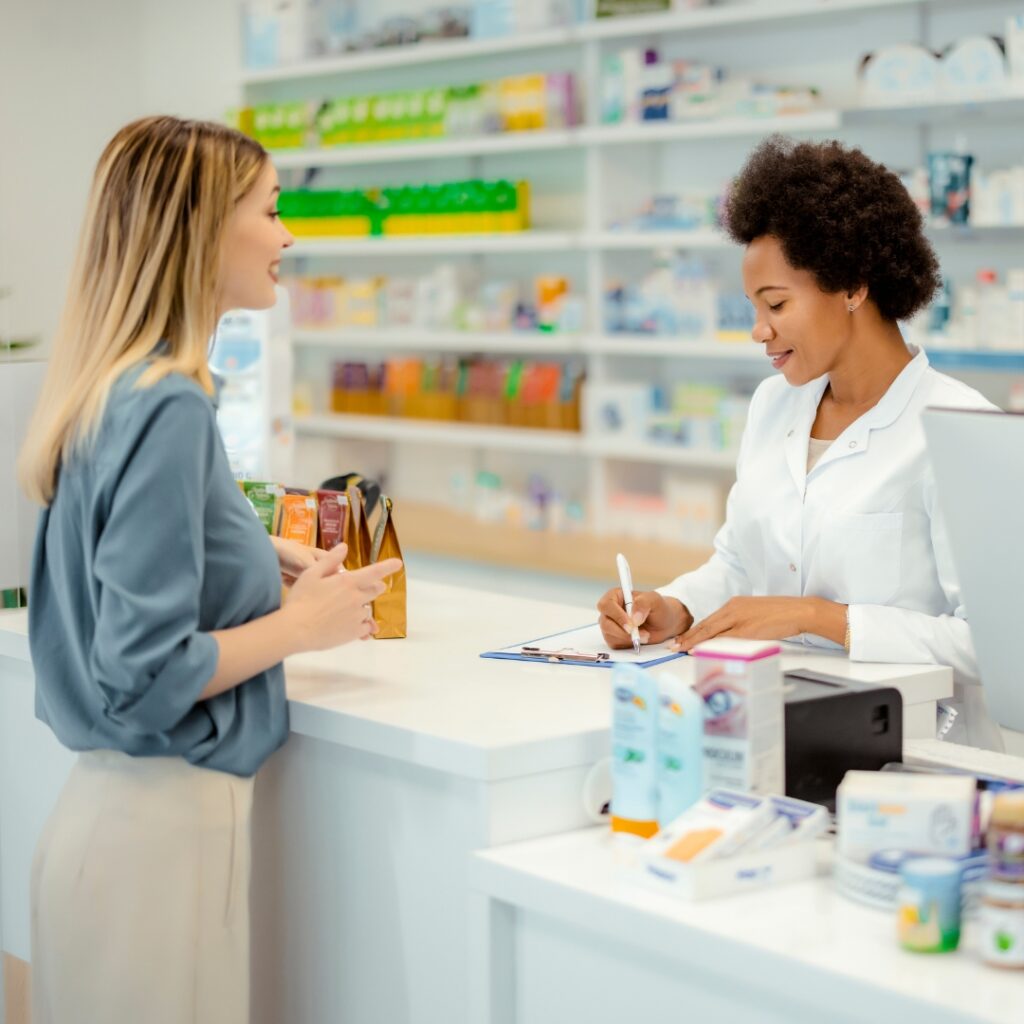 a photo of a lady speaking to a pharmacist