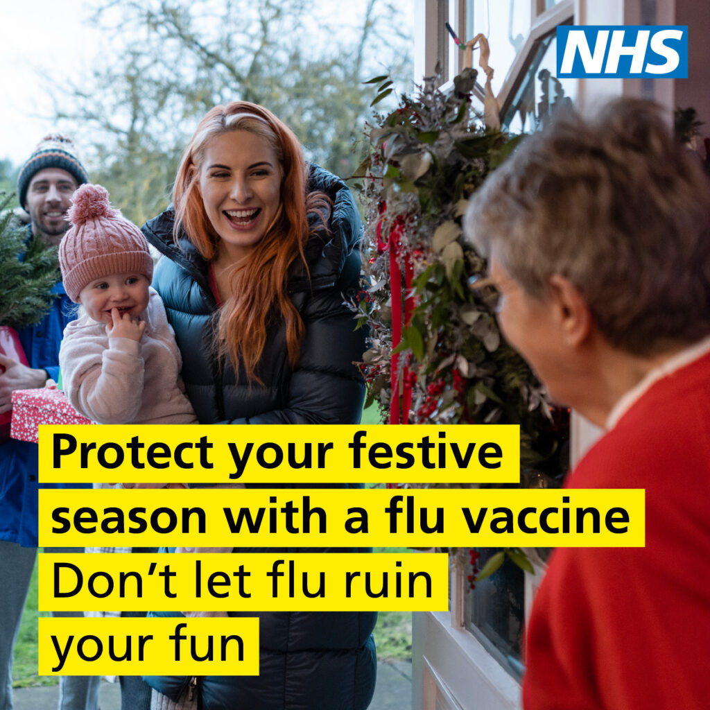 A mother holding her child at a door decorated with festive greenery, promoting flu vaccination for a healthy holiday season.