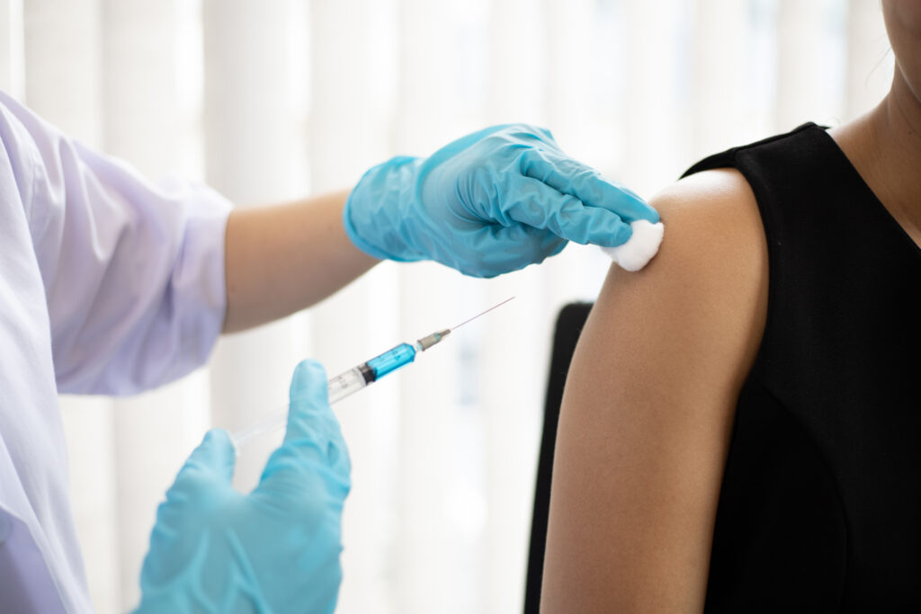 Photograph of a woman being vaccinated in her shoulder